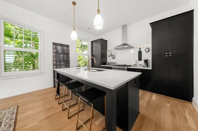 a kitchen with a table chairs refrigerator and cabinets