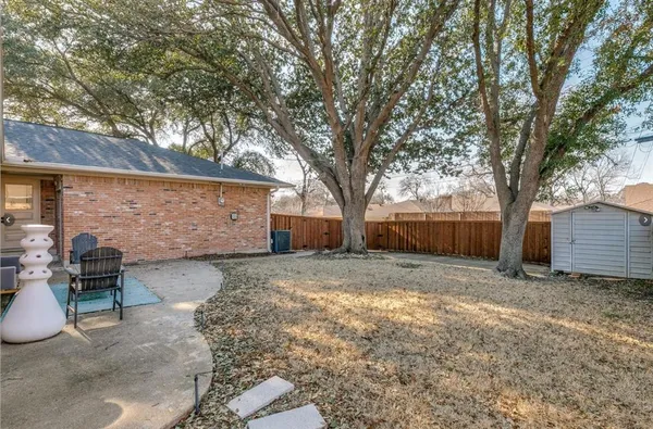 a view of a backyard with large tree