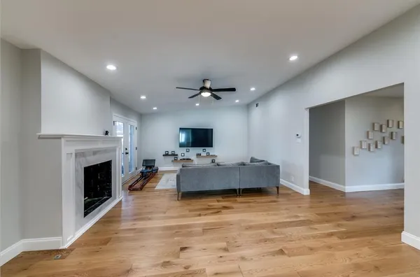 a living room with furniture a fireplace and a flat screen tv