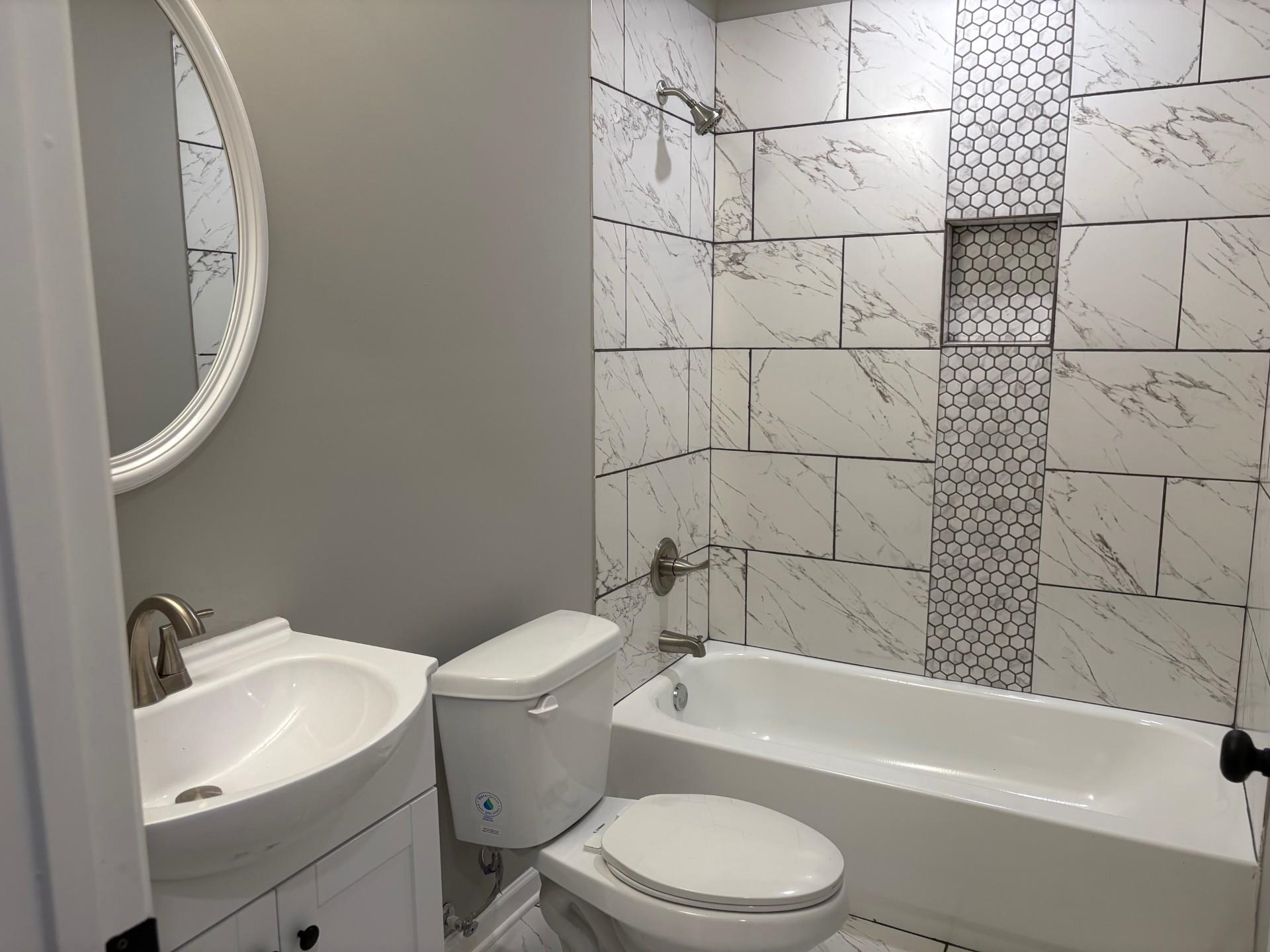 3701 Whittier Road Memphis, TN 38108 - Photo 7 of 13 Bathroom featuring washtub / shower combination and vanity
