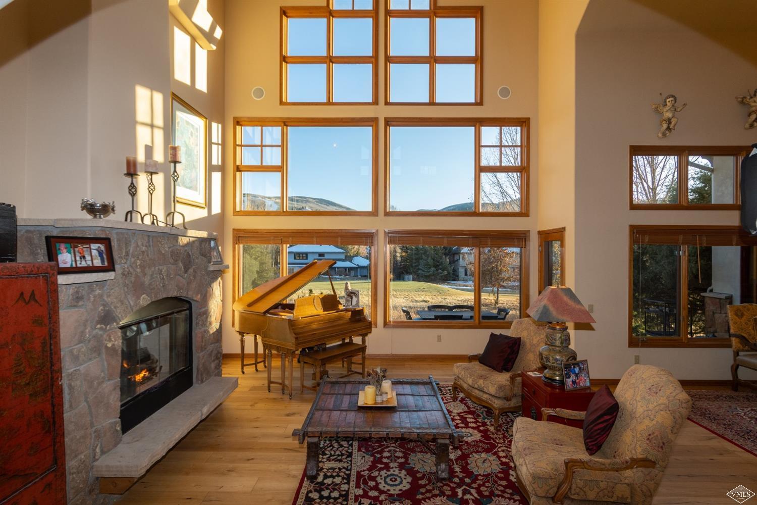a living room with furniture a fireplace and windows