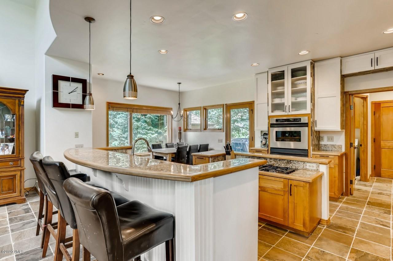 145 Hereford Road Edwards, CO 81632 - Photo 11 of 24 a kitchen with stainless steel appliances granite countertop a stove a sink and a microwave