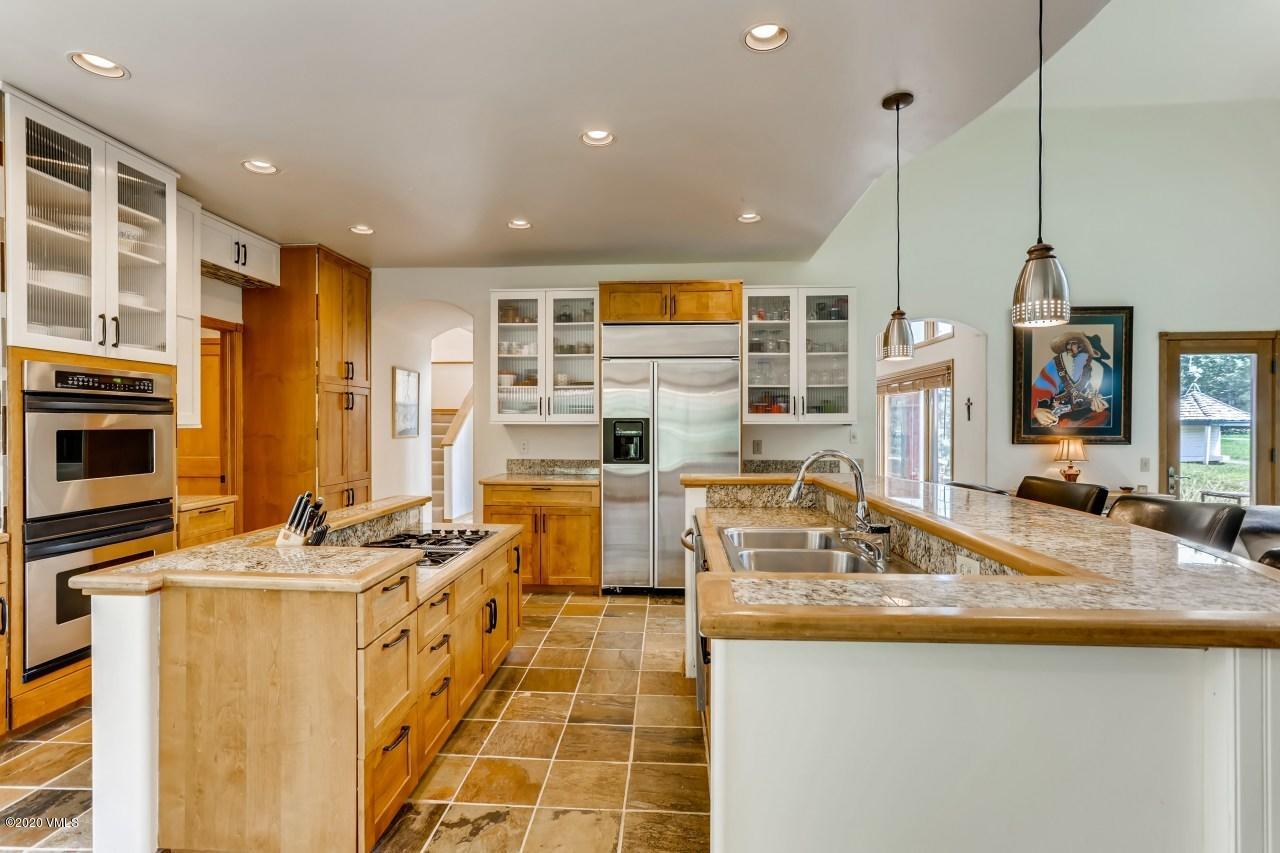 145 Hereford Road Edwards, CO 81632 - Photo 12 of 24 a kitchen with stainless steel appliances granite countertop a sink stove and refrigerator