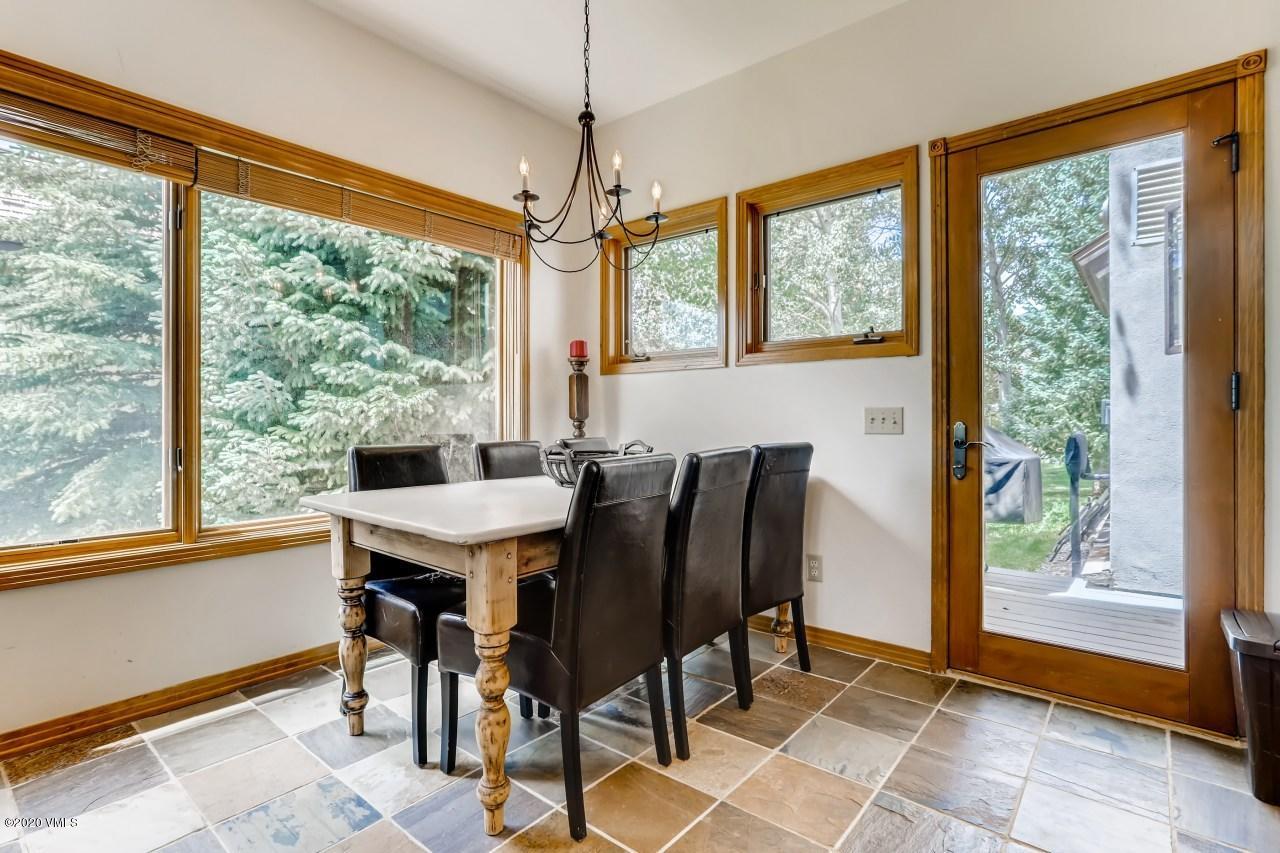 145 Hereford Road Edwards, CO 81632 - Photo 10 of 24 a view of a dining room with furniture large windows and wooden floor