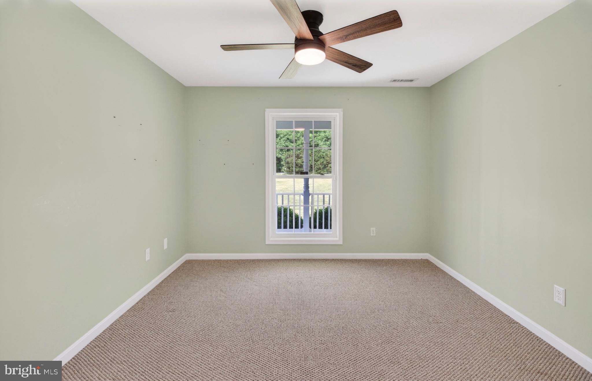 18315 Atlanta Road Bridgeville, DE 19933 - Photo 14 of 28 an empty room with a window and a fan