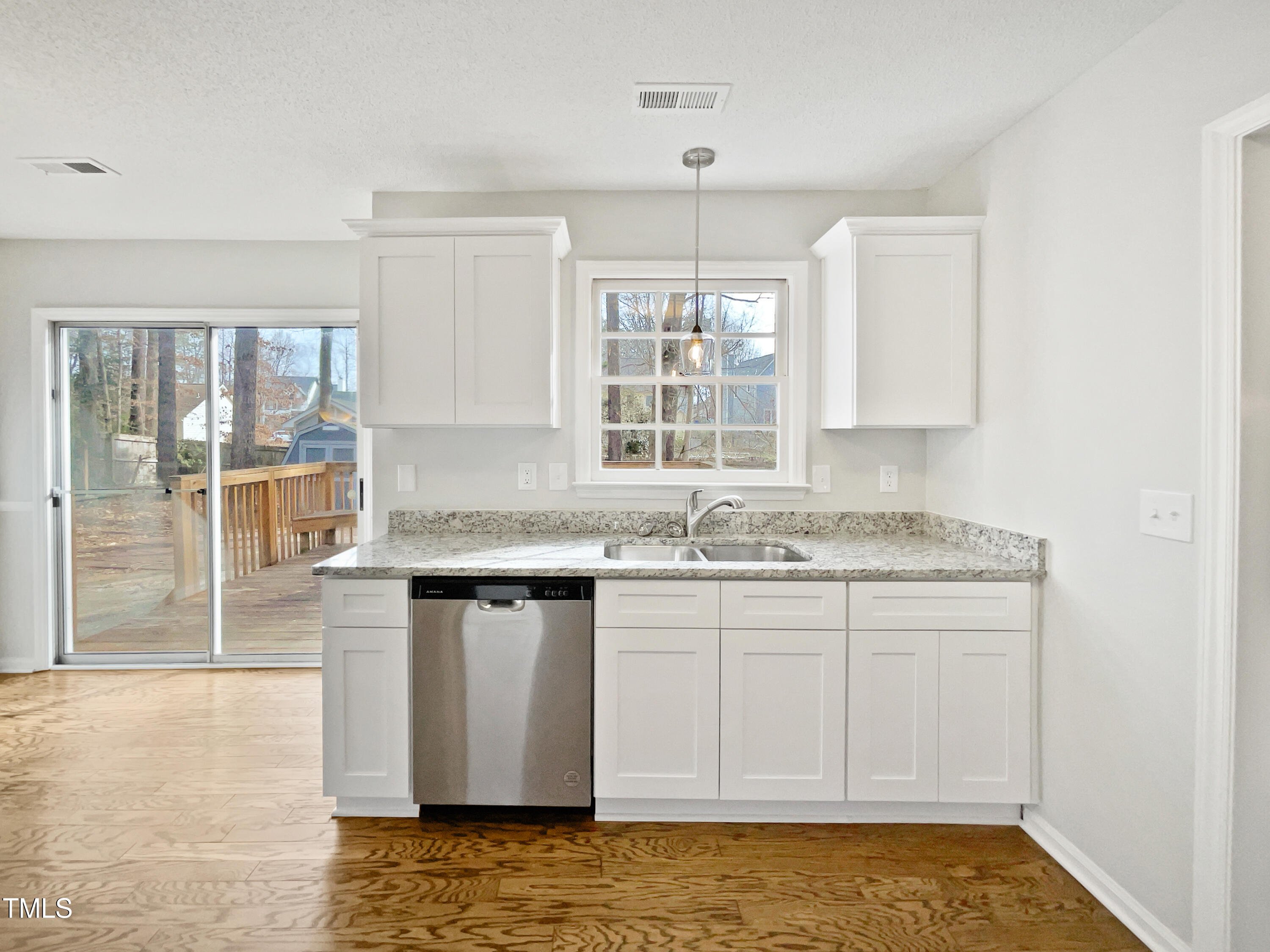 3604 Tunas Street Raleigh, NC 27616 - Photo 14 of 21 a kitchen with granite countertop a sink and a stove