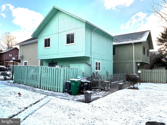 a view of a house with wooden fence