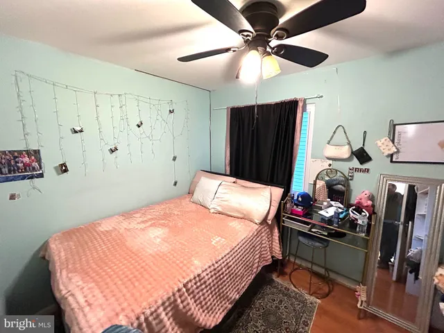 a bedroom with bed and a chandelier