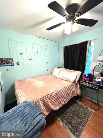 a bedroom with a bed a dresser and a window