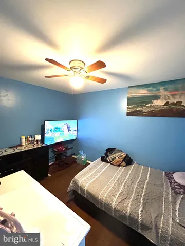 a bedroom with a bed and a desk