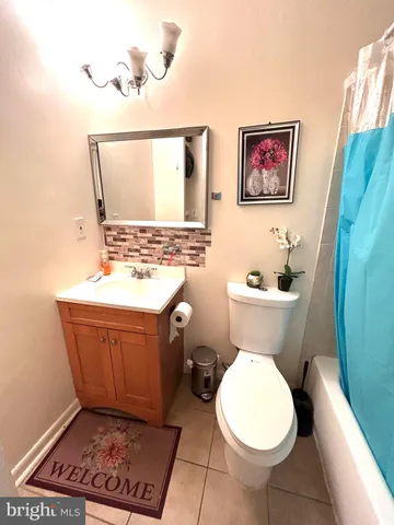 a bathroom with a toilet a sink and a mirror