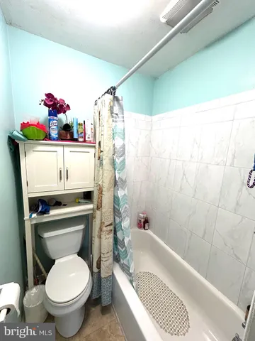 a bathroom with a sink a toilet and bathtub