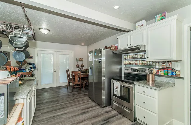 a kitchen with stainless steel appliances granite countertop a stove and cabinets