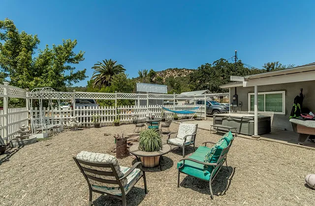 a view of a chair and tables in the patio