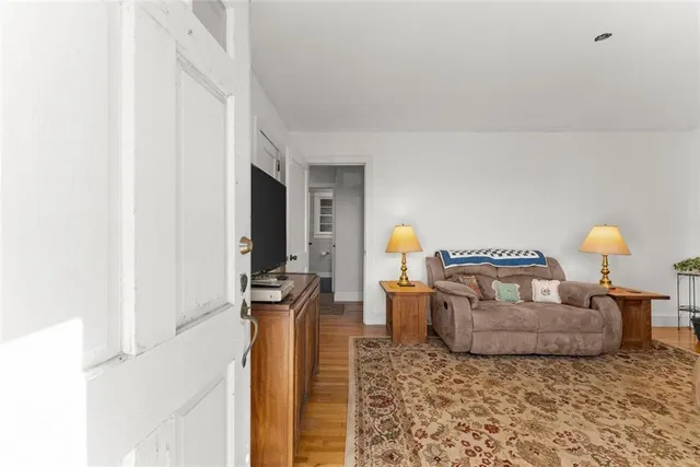 a living room with furniture and a lamp