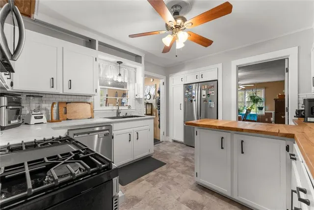 a kitchen with stainless steel appliances granite countertop a stove and a sink