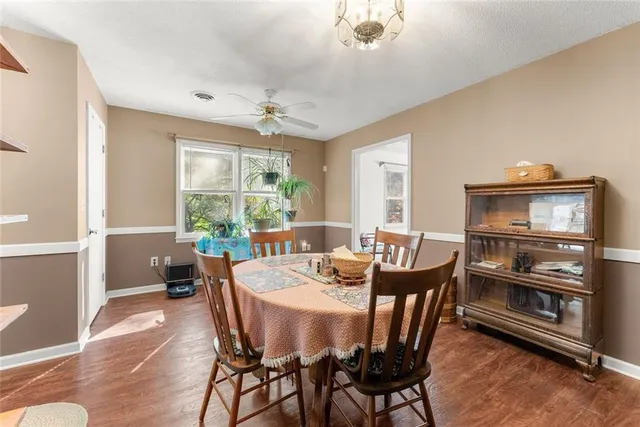 a dining room with furniture a rug and wooden floor