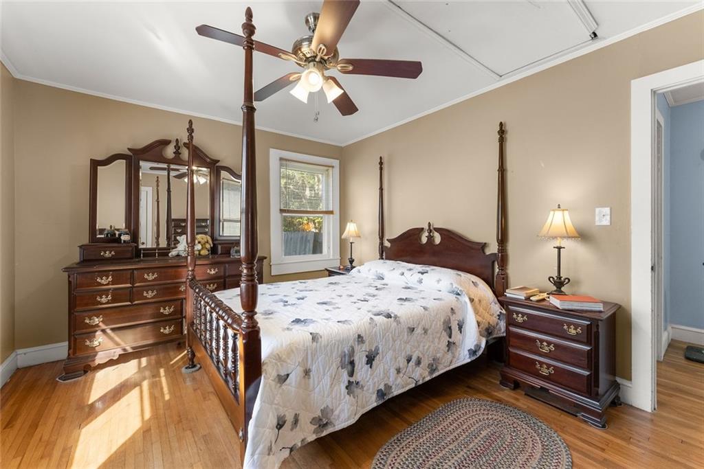3089 Highway 17 Alternate Toccoa, GA 30577 - Photo 21 of 51 a bedroom with a bed a chandelier and dresser