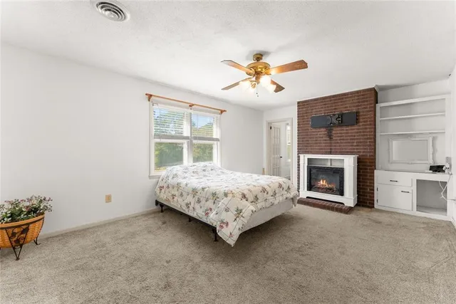a bedroom with a bed and a fireplace