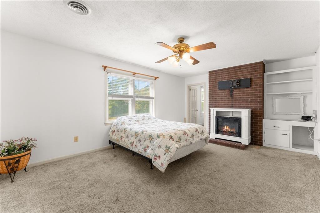 3089 Highway 17 Alternate Toccoa, GA 30577 - Photo 26 of 51 a bedroom with a bed and a fireplace