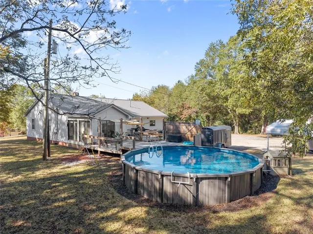 a view of a house with pool table and chairs