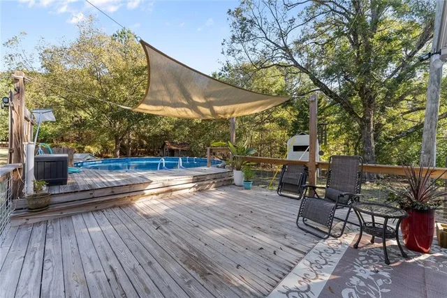 a view of a patio with table and chairs potted plants and large tree
