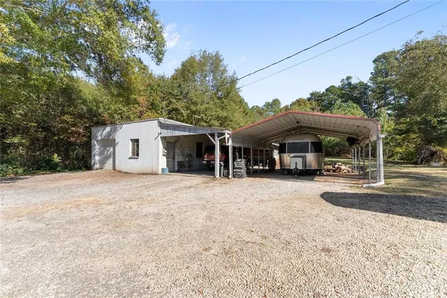 a view of a house with a yard and sitting area