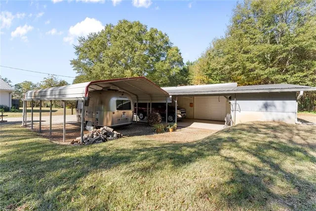 a front view of a house with a yard and trees