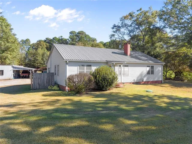 a view of a house with a yard and garage