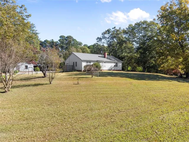 a swimming pool with trees in front of it