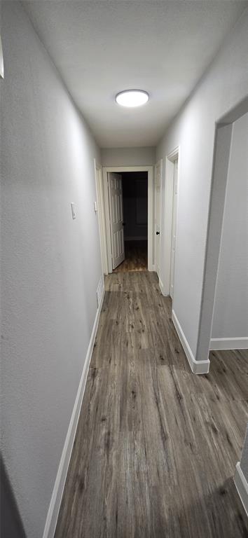 405 Southwest 6th Street Grand Prairie, TX 75051 - Photo 6 of 16 Hall with dark wood finished floors and baseboards