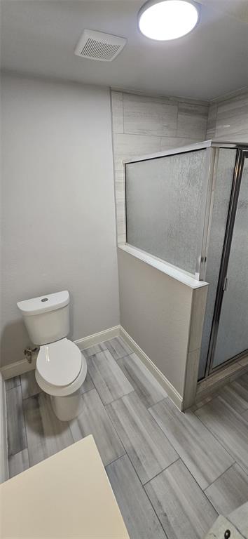 405 Southwest 6th Street Grand Prairie, TX 75051 - Photo 8 of 16 Full bath with wood tiled floors and a shower stall