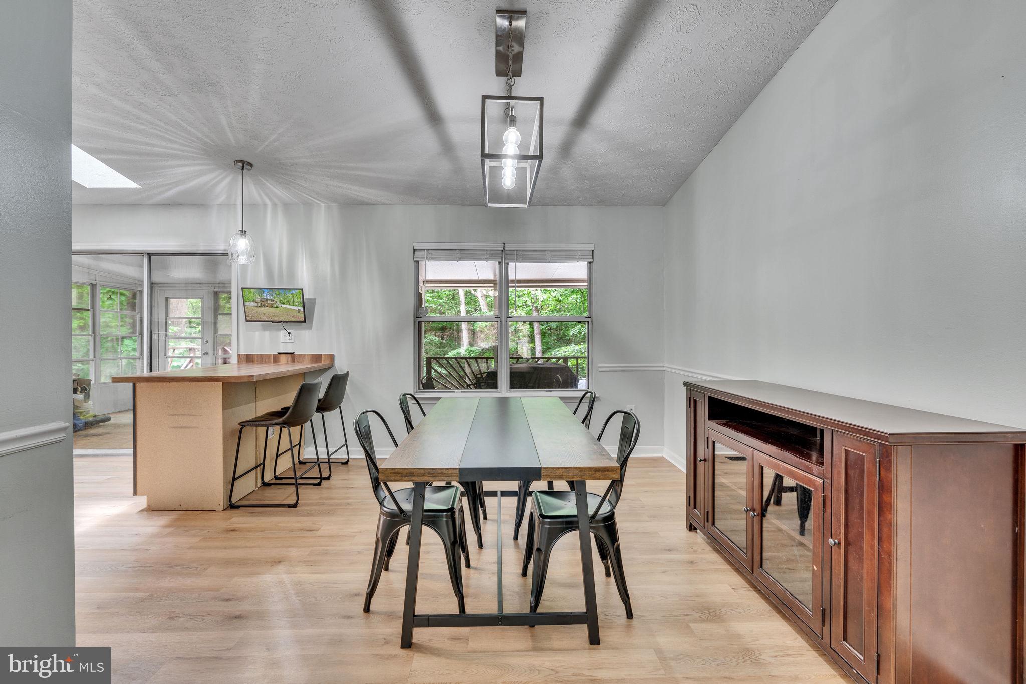 486 Round Up Road Lusby, MD 20657 - Photo 5 of 31 a view of a dining room with furniture window and wooden floor