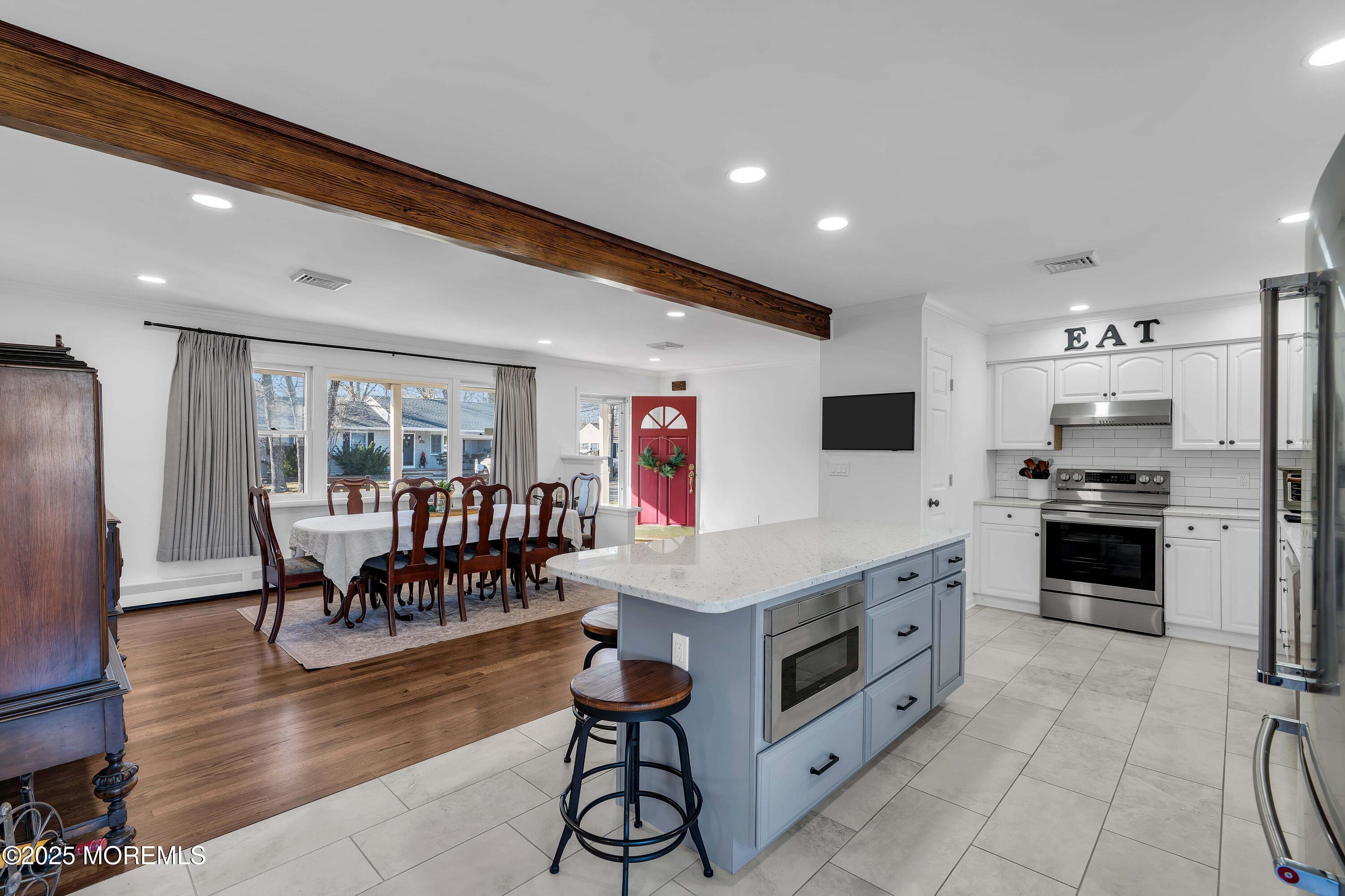 520 Windsor Street Forked River, NJ 08731 - Photo 14 of 36 a kitchen with stainless steel appliances kitchen island granite countertop a refrigerator and microwave