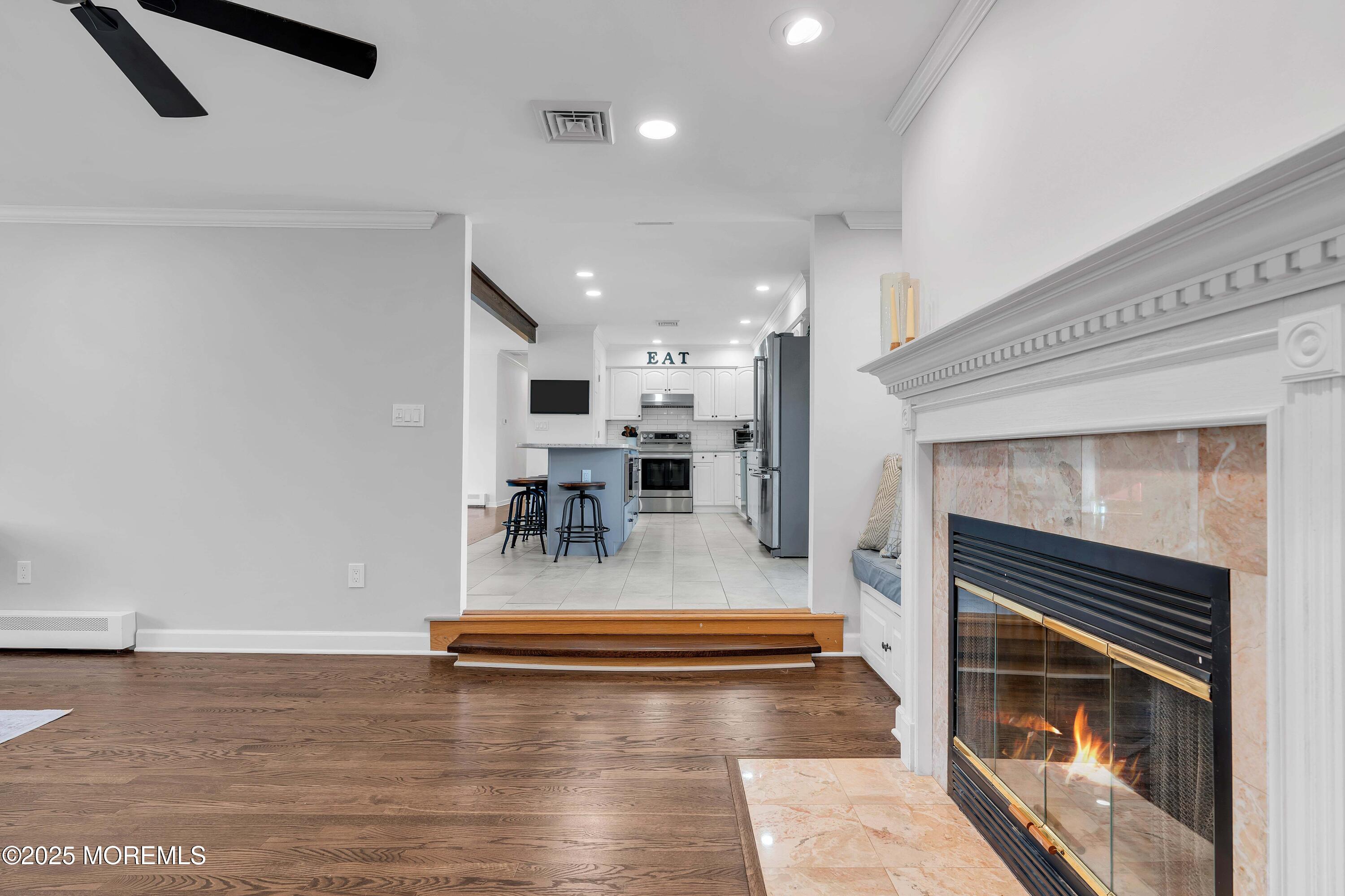 520 Windsor Street Forked River, NJ 08731 - Photo 20 of 36 a living room with fireplace furniture and a wooden floor