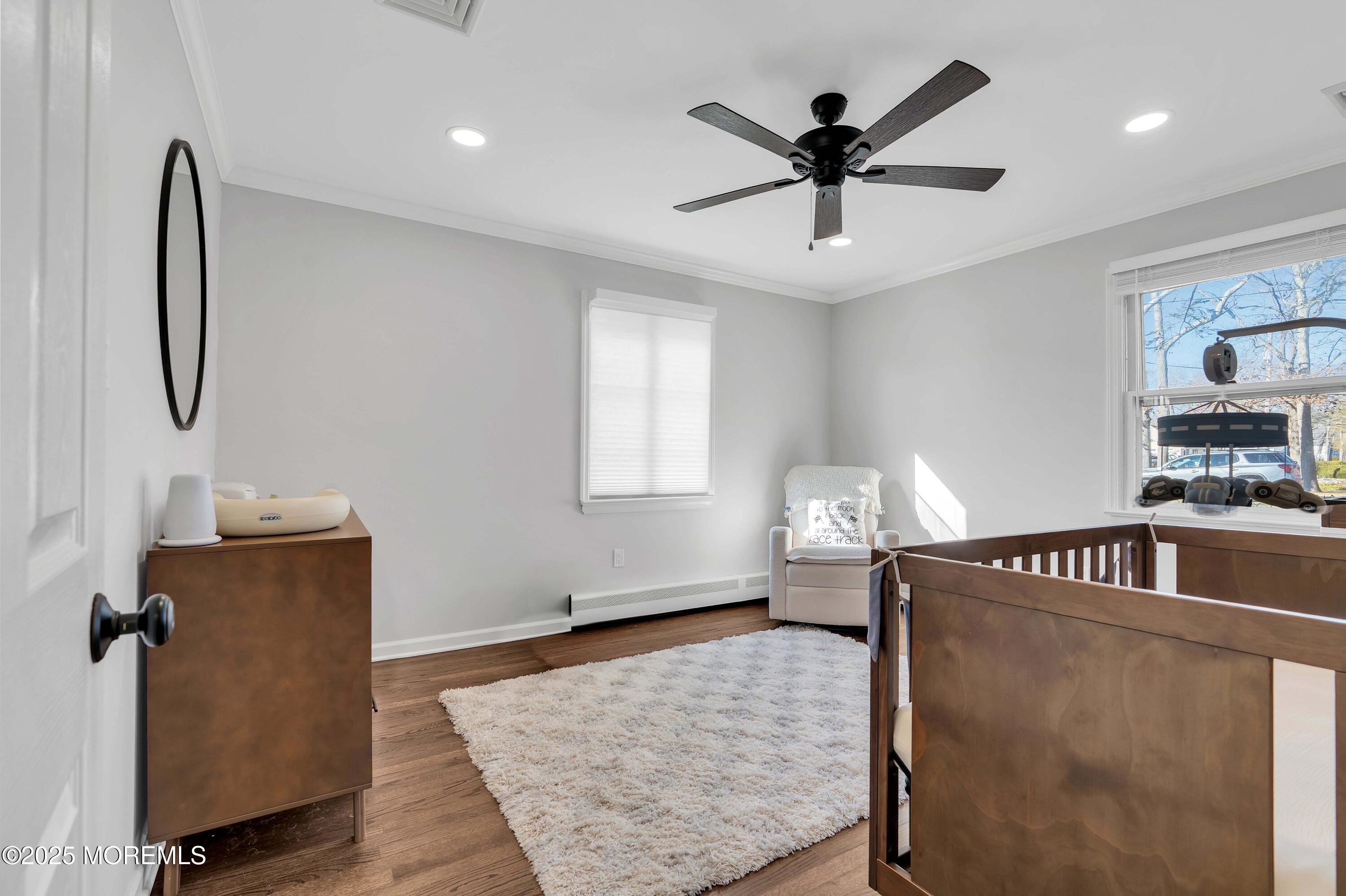 520 Windsor Street Forked River, NJ 08731 - Photo 21 of 36 a living room with hard wood floors and a ceiling fan