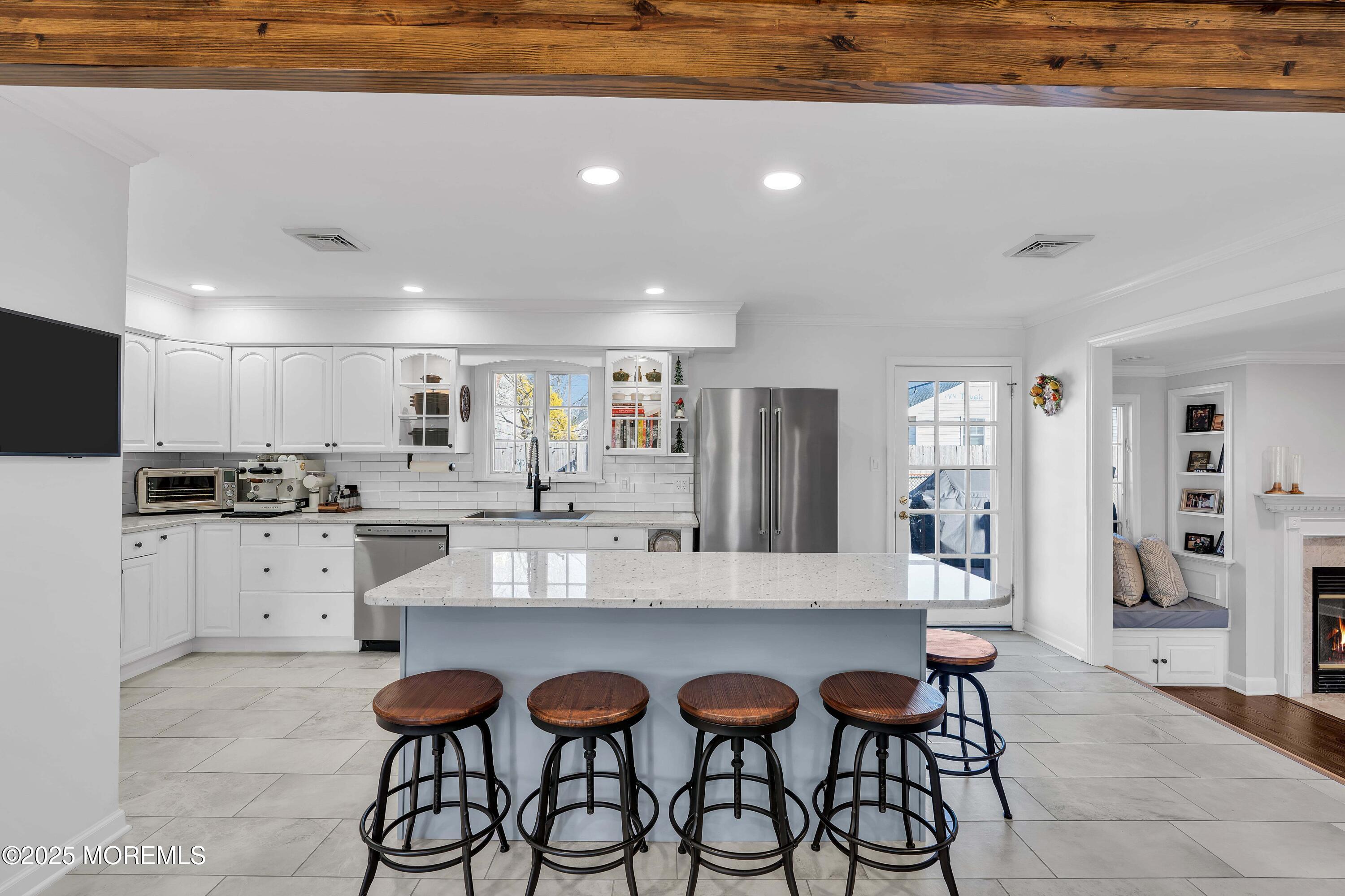 520 Windsor Street Forked River, NJ 08731 - Photo 3 of 36 a kitchen with stainless steel appliances kitchen island granite countertop a dining table and chairs