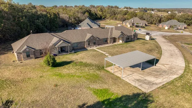 a view of a house with pool and yard