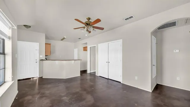 a view of a kitchen with a sink and a refrigerator