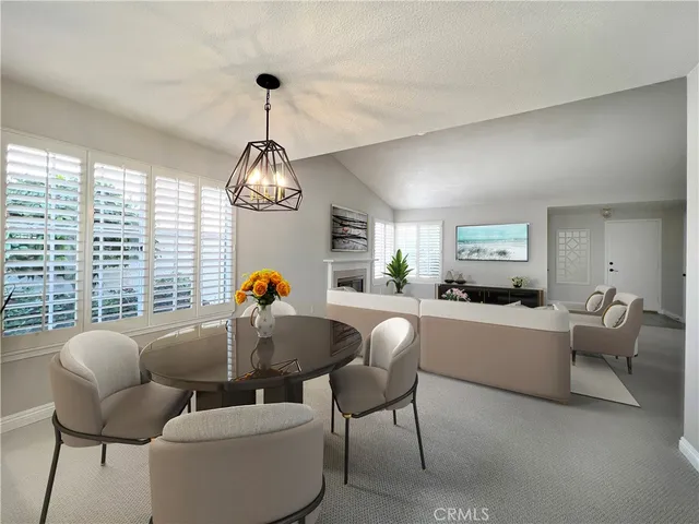 a living room with furniture a chandelier and a window