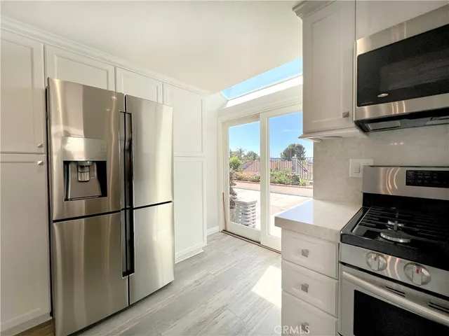 a kitchen with stainless steel appliances a refrigerator stove and microwave