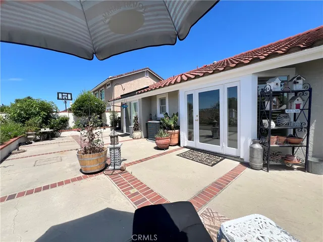 a view of a patio with table and chairs and potted plants