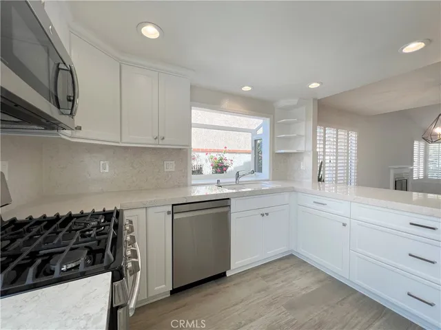 a kitchen with sink and cabinets
