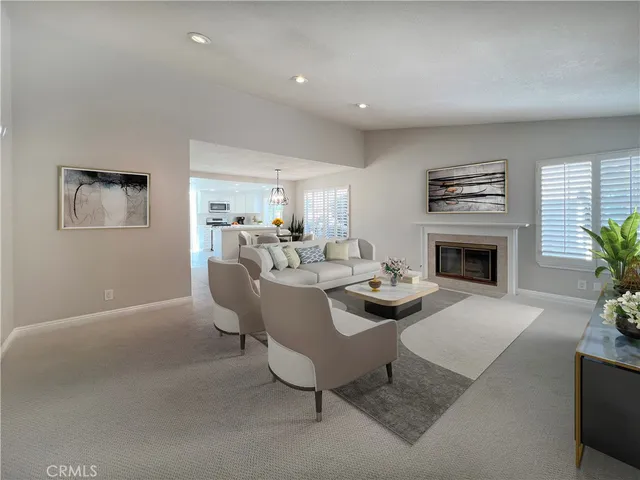 a living room with furniture a window and a fireplace
