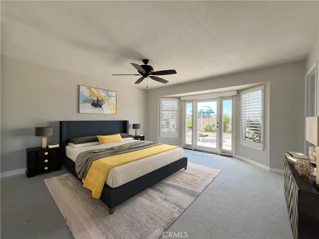 a bedroom with a large bed and a large window