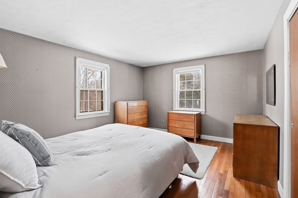 49 Jackson Road Scituate, MA 02066 - Photo 14 of 25 a bedroom with a bed and a dresser next to a window