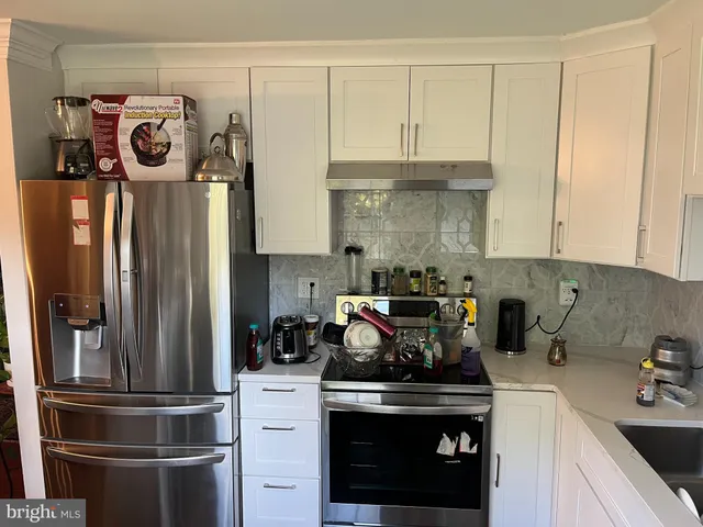 a kitchen with a refrigerator and cabinets