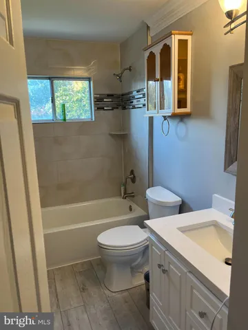 a bathroom with a toilet sink and shower