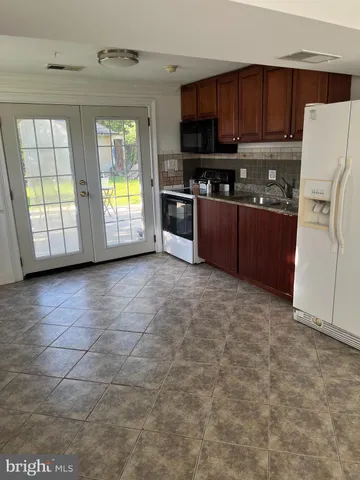 a kitchen with stainless steel appliances a refrigerator and a stove top oven