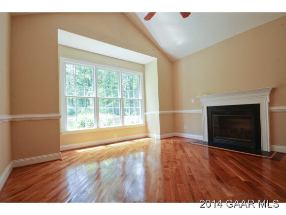 1834 Hermitage Road Waynesboro, VA 22980 - Photo 9 of 32 a view of an empty room with wooden floor fireplace and a window